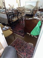 View of small to medium rugs among furniture, showing rug sizes and placement in room.