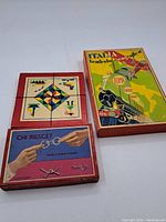 Three vintage Italian toys in original boxes, showing the wooden puzzle, metal ring puzzle box, and Italiana Bombala cribbage board game box with colorful illustrations.