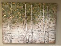 Front view of the abstract birch tree canvas painting showing textured bark details and green foliage with gold leaves.