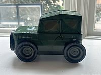 Photo of green Jeep-shaped puzzle showing side angle with star and army markings visible