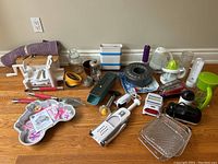 Image of assorted kitchen tools including mandolin slicer, graters, kettle, cake mould, citrus juicer and other kitchen gadgets.