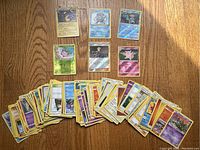 Spread of various Pokémon cards showing holographic and regular cards including characters like Poliwag, Clefairy, and Jigglypuff and many others.
