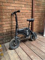 Full side view of the black Lectron C5-12 electric bike showing frame, tires, seat.