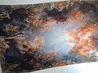 Full view of the large cloth print affixed to the ceiling, showing detailed Renaissance art scenes.