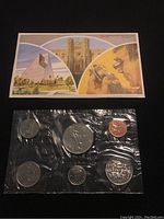 Photo of the front side of the sealed 1980 Canadian uncirculated coin set with six coins visible in plastic packaging and an informational display card showing Canadian imagery.