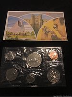 Photo of front and reverse sides of 1981 uncirculated Canadian coins sealed in plastic with illustrated card