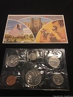 Set of six sealed Canadian 1982 coins with an original illustrated informational envelope above