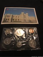 Photo showing front of original Canadian Mint card with building image and sealed uncirculated coins.