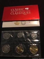 Front view of the 2017 Classic Canadian Coin Set with eight uncirculated coins in sealed plastic packaging and red collector's envelope.