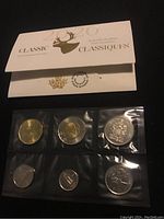 Front side of the Classic Uncirculated Coin Set folder showing six Canadian coins sealed in plastic including gold-tone and silver-tone coins.
