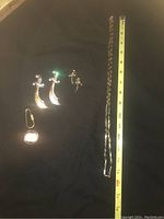 Full set: long chain necklace, two sword-shaped dangle earrings, two matching pins, ruler for scale
