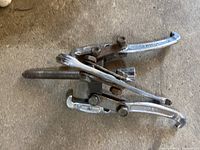 3 Arm Gear Puller showing three metal arms with hooks and central threaded shaft