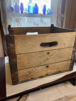 Wooden Briars Dairy crate front view showing metal side frames, wooden slats and branded text.