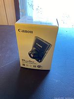 Front of sealed Canon PowerShot ELPH190 IS box showing camera image and key features