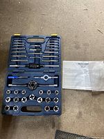 Full set in closed blue molded plastic carrying case with tools and instruction manual laid out