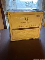Front view of the Clara Clark Premier 1800 Collection queen bedding set packaging with brand and product information visible.