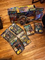 Lot of Spawn action figures mostly still in packaging with one open box chopper motorcycle figure shown on hardwood floor.