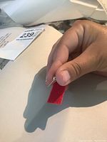 Close-up view of one gold ball stud earring from front showing spherical shape and polished finish.