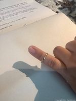 Wedding band worn on finger showing size and style.