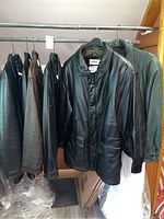 Five jackets hanging on metal garment rack