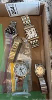Full view of all 5 watches in box: Swiss Army, Marc Ecko, two Gruen Veri-Thin, Timex Indiglo on stand