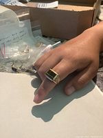 Ring worn on finger showing top view of stone and setting