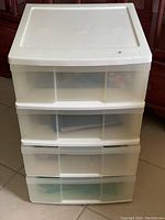 White 4 drawer plastic storage tower front view, showing semi-transparent drawers