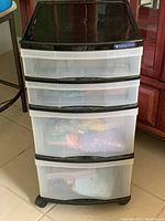 4 drawer plastic storage tower on wheels with translucent drawers and black trim