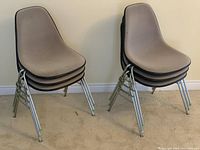 Two stacks of three gray Eames-style chairs showing full lot arrangement