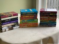 Books stacked on two sides, showing a range of authors surnames starting with 'E' and multiple Janet Evanovich titles