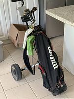 Golf bag and clubs on push caddy showing overall set and bag branding