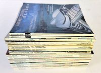 Stack of 25 architectural design magazines from 1980s to 2000s, showing variety of publication titles and dates on spines.