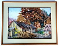 Framed pastel painting of a peaceful rural landscape showing three old wooden buildings surrounded by vibrant autumn trees. The painting is signed by the artist and protected under glass with white matting and a brown wood frame.