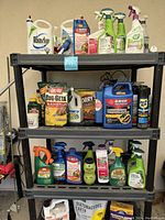 Full view of plastic shelving unit holding many different insecticide, weed killer, rodent control bottles and packages.