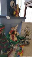 Photo showing overall lot including St. Nicholas figures, gourmet serving tree, and Rubbermaid storage tote.