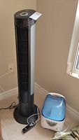 Full view of Seville Classics tower fan next to Vicks humidifier.