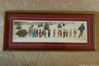 Full view of the framed and matted print showing children walking in snow and a woman pulling a wagon with a Christmas tree.