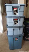 Four stacked Rubbermaid totes: three smaller 38L sized with lids, one larger 68.1L sized with lid. All light blue with darker blue lids. Lids fit securely except the 68.1L tote lid is missing as shown in the second photo.