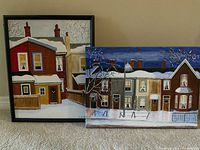 Photo of two original winter house paintings on canvas, one framed, one unframed, both signed L Morgan 10