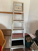 Front view of the aluminum step ladder showing the six steps and rectangular top platform.