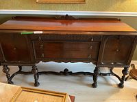 Front view of the full buffet showing cabinet doors, drawers, and legs