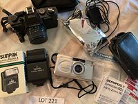 Overview photo of all cameras and accessories included in the lot.