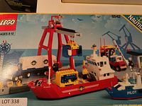 Front of box showing assembled models: cargo ship, pilot boat, crane, truck and containers