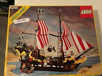 Front of LEGO box showing set number 6285, Black Seas Barracuda artwork and minifigures on deck