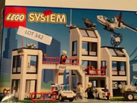 Front of LEGO System police station box showing built set with police figures, police car, and helicopter.