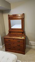Full view of the dresser with attached mirror showing condition and style.