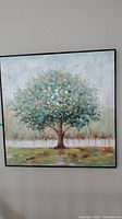 Full view of the framed tree painting showing the colors and frame.