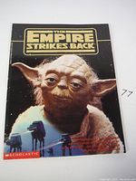 Front cover of The Empire Strikes Back storybook showing embossed Yoda figure with hair details and story text.