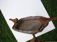 Front angle showing the shallow basin with two bird figures at sides