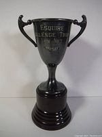 Full view of the vintage trophy with Bakelite base against a plain background showing the overall condition and profile.